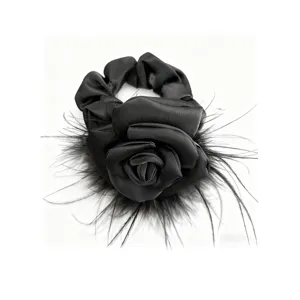 Elegant black satin camellia flower hair scrunchie with soft ostrich feather trim