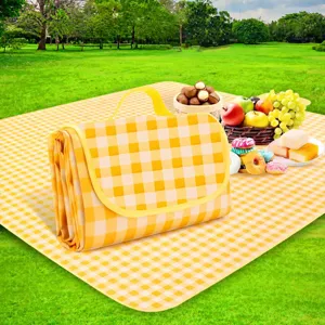 Outdoor portable waterproof picnic blanket with yellow plaid pattern and handy folding design.