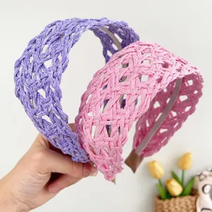 Close-up detail of hand-woven straw headbands in purple and pink for a summer resort look