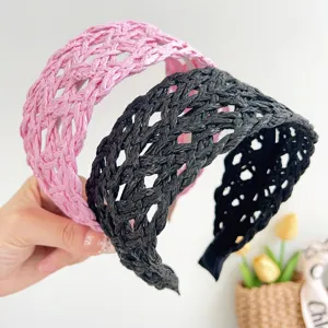 Detailed view of pink and black woven straw headbands with summer vacation style