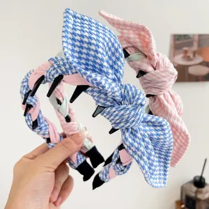 Detail view of houndstooth rabbit ear headband with braided twist and non-slip teeth