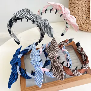 Detail of vintage houndstooth headbands featuring a rabbit ear knot and anti-slip teeth.
