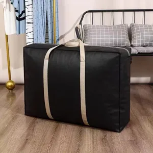 Large capacity black storage bag for quilts, clothes, and bedding. Durable non-woven fabric.