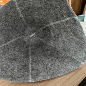 Close-up detail of grey felt sauna hat with durable white reinforced stitching
