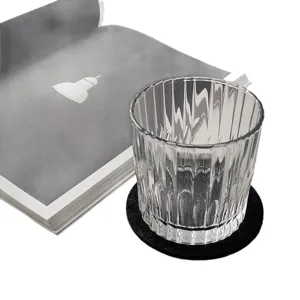 Absorbent round black felt coaster for plants or cups on a clean white background.