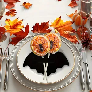 Detailed view of a Halloween bat-shaped felt cutlery holder and candy clip on a plate