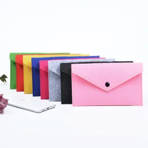 Detail showing a colorful collection of felt envelope pouches with a scale reference