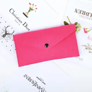 Detailed close-up view of a vibrant pink felt multipurpose storage pouch with snap button
