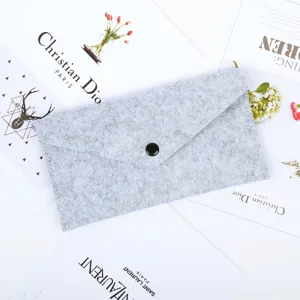 Detail view of the gray felt envelope storage bag featuring a secure black snap button
