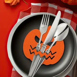 Close-up view of a Halloween pumpkin felt cutlery holder with stainless steel tableware