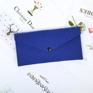 Close-up of a royal blue felt envelope-style pouch featuring a black snap button closure