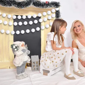 Festive Christmas white wool ball garland shown in a cozy indoor holiday home scene decoration