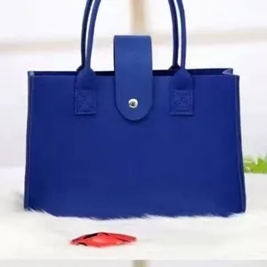 Durable blue felt tote bag with handles and snap closure for travel and shopping use
