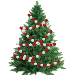 Red and white wool felt ball garland wrapped around a green Christmas tree