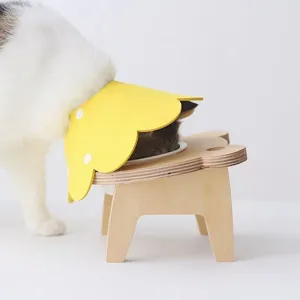 Detailed side view of a cat in a yellow sunflower Elizabeth collar eating from a bowl
