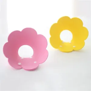 Adjustable sunflower-shaped pet Elizabeth collars in pink and yellow with snap buckles.