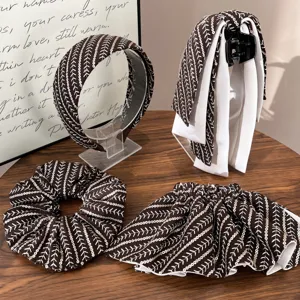 Detail view of sequined hair accessory set including headband and scrunchie.