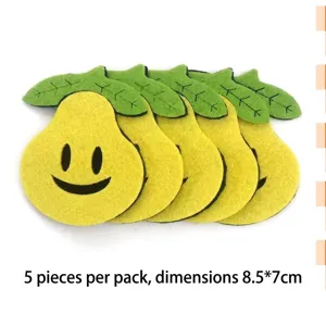 Detailed view of yellow pear-shaped felt patches with smiley faces and leaves for crafts.