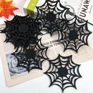 Macro view of laser-cut black felt spider web placemat for Halloween table decoration