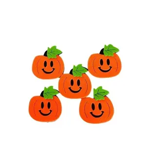 Detailed view of five cute felt pumpkin decorations with smiley faces for DIY crafts