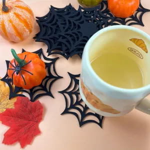 Black spider web felt placemat set with Halloween pumpkins and autumn leaf decor
