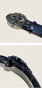 Detailed view of the vintage Mongolian style carved metal buckle and dark leather belt strap.