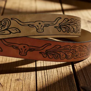 Western cowboy style leather belt featuring a classic cow skull and leaf print design.