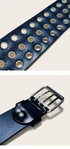 Close up detail view of wide black leather punk belt featuring multiple rows of metal grommets.