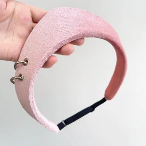 Detail of pink velvet headband with stylish silver rings and soft padding