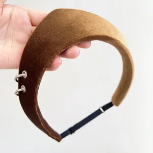 Detailed view of a vintage brown velvet headband featuring decorative silver rings