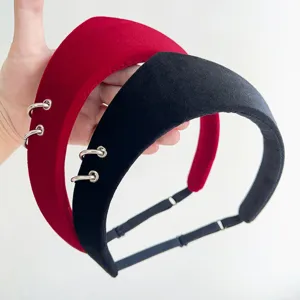 Close-up view of vintage velvet headbands with silver metal rings in red and black