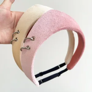 Close-up of velvet padded headbands with metal rings and adjustable straps