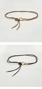 Detail view of thin leather waist belt with metallic hook buckle and tips for dress coat styling.