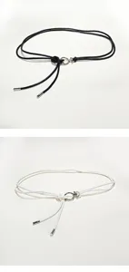 Detailed view of thin leather cord waist belt with metal ring decor, versatile for women apparel.