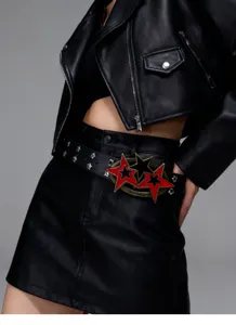 Punk style black leather belt with red and black pentagram star buckle and metal eyelets.