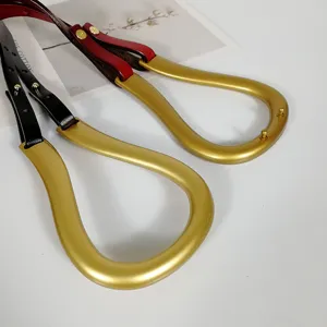 Detailed view of luxury leather belt with elegant golden stirrup metal buckle hardware.
