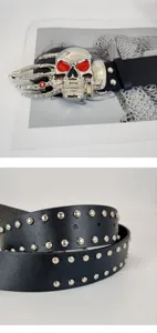 Punk style black leather belt featuring a silver skull hand buckle and metal rivets design.