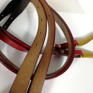 Slim genuine leather belt detail shot with metal tips, perfect accessory for dresses and coats.