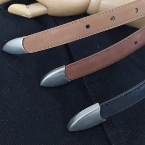 Women's slim leather belt with metal tip set, stylish everyday accessory for jeans and dresses.