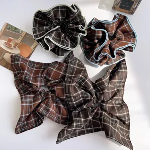 Detailed collection of vintage brown plaid hair scrunchies and ribbons with ruffles