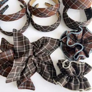 Close-up of brown retro plaid headband and pleated scrunchie hair accessories set