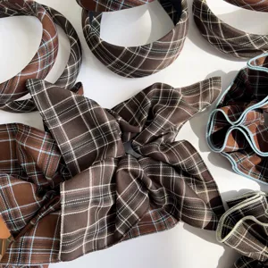 Detail view of vintage brown plaid scrunchies and headband set for autumn hairstyles.