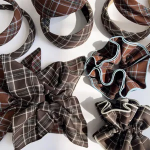 Close-up of retro brown plaid headband and pleated hair scrunchies set for women.