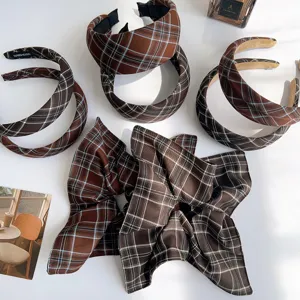 Detailed view of brown plaid headbands and oversized ruffled bow hair accessories.