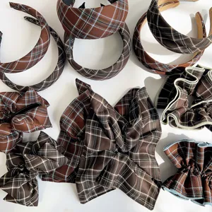 Detailed overhead view of vintage brown plaid headbands and pleated fabric hair scrunchies.