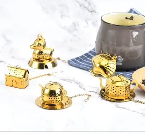Set de infusores de té de acero inoxidable dorado con formas adorables de tetera y casa.