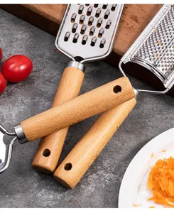 Stainless steel vegetable grater with wooden handle, kitchen food slicer and shredder tool.