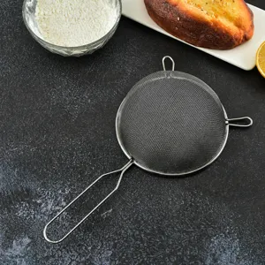 Stainless steel flour sieve with fine mesh and long handle for baking and kitchen use.