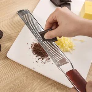 Stainless steel cheese grater and lemon zester with wooden handle for kitchen use.