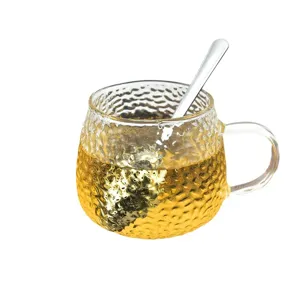 Transparent hammered glass tea cup with spoon, clear mug for drinking tea or daily use.